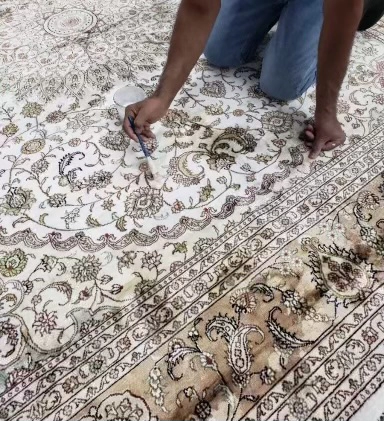 Technician repairing oriental rug